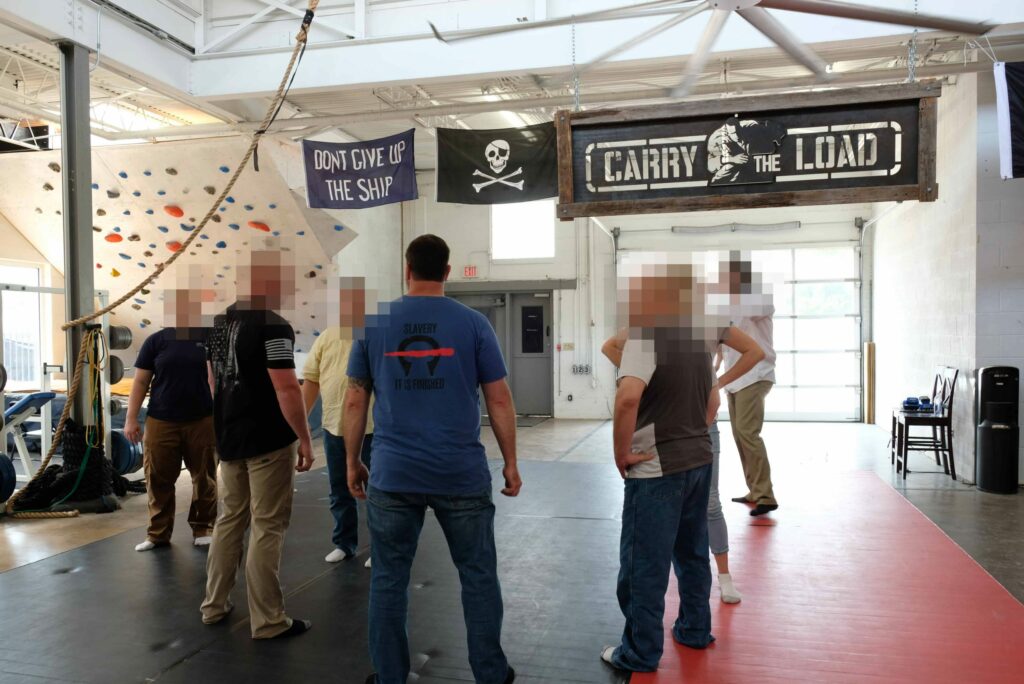 Michael Fullilove with investigators in a training facility