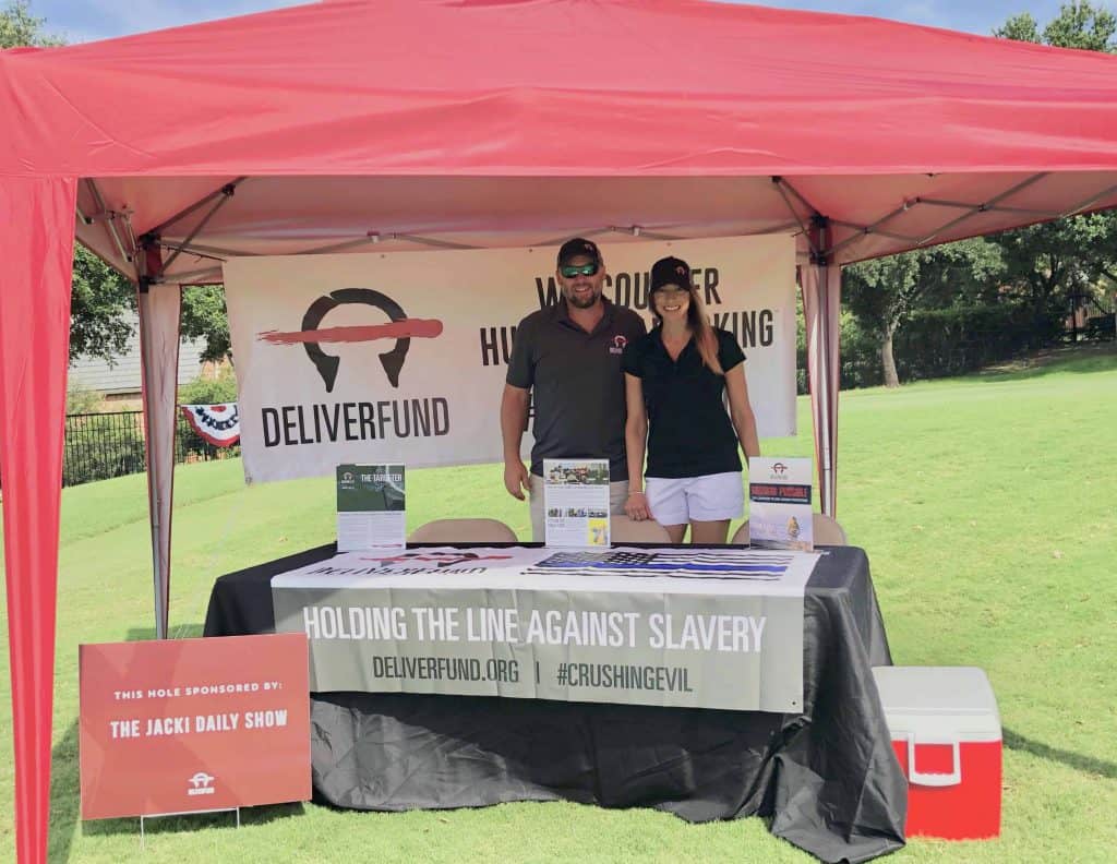 Britney and Jeremy Mahugh at the golf course under a DeliverFund tent