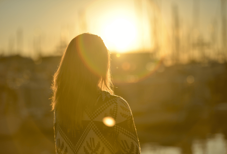 Young girl watching the sunset