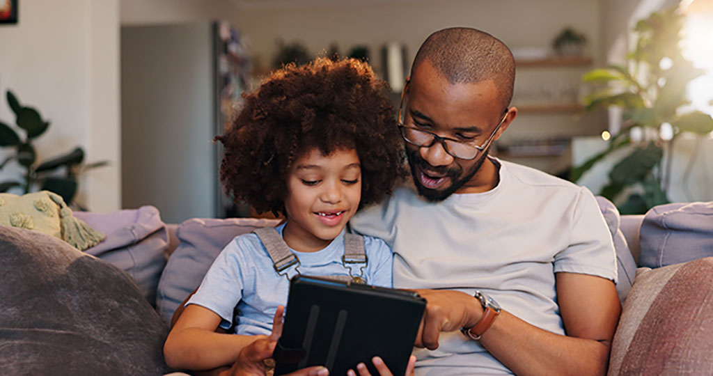 Parent and child looking at a tablet together